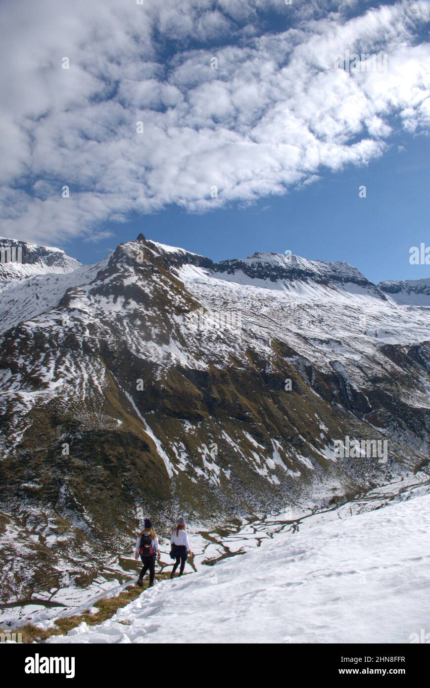 Excursionistas en el paisaje nevado de montaña en el parque nacional Hohe Tauern en Tirol, Austria Foto de stock