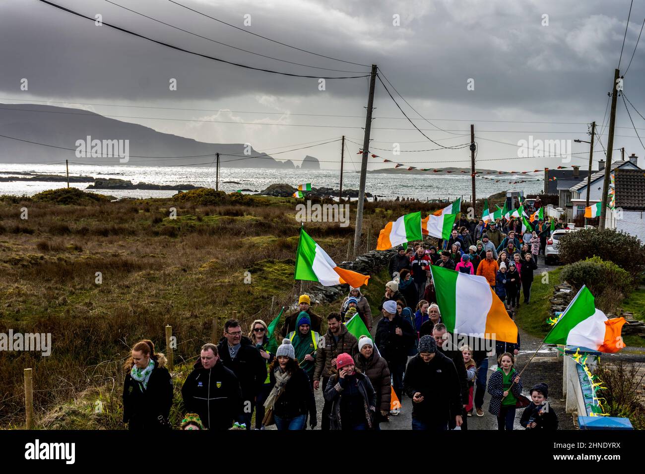 Los aldeanos participan en el desfile del día de San Patricio por el pueblo costero del Océano Atlántico de Rosbeg, Condado de Donegal, Irlanda Foto de stock