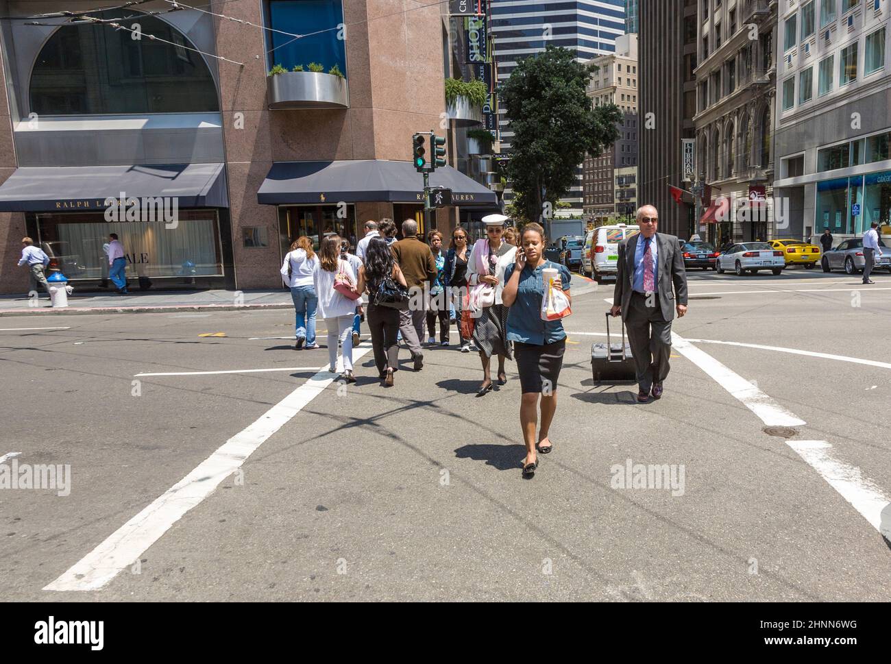 La gente espera en un cruce peatonal para que la luz verde cruce la calle en San Francisco Foto de stock