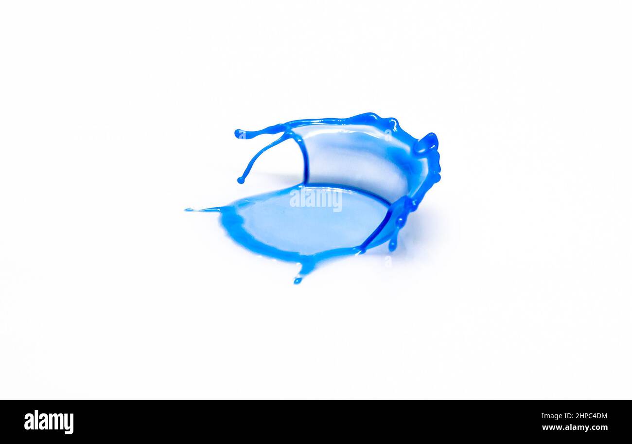 Una gota de agua de color azul que golpea un plato blanco da forma a un sillón. Foto como decoración de pared Foto de stock