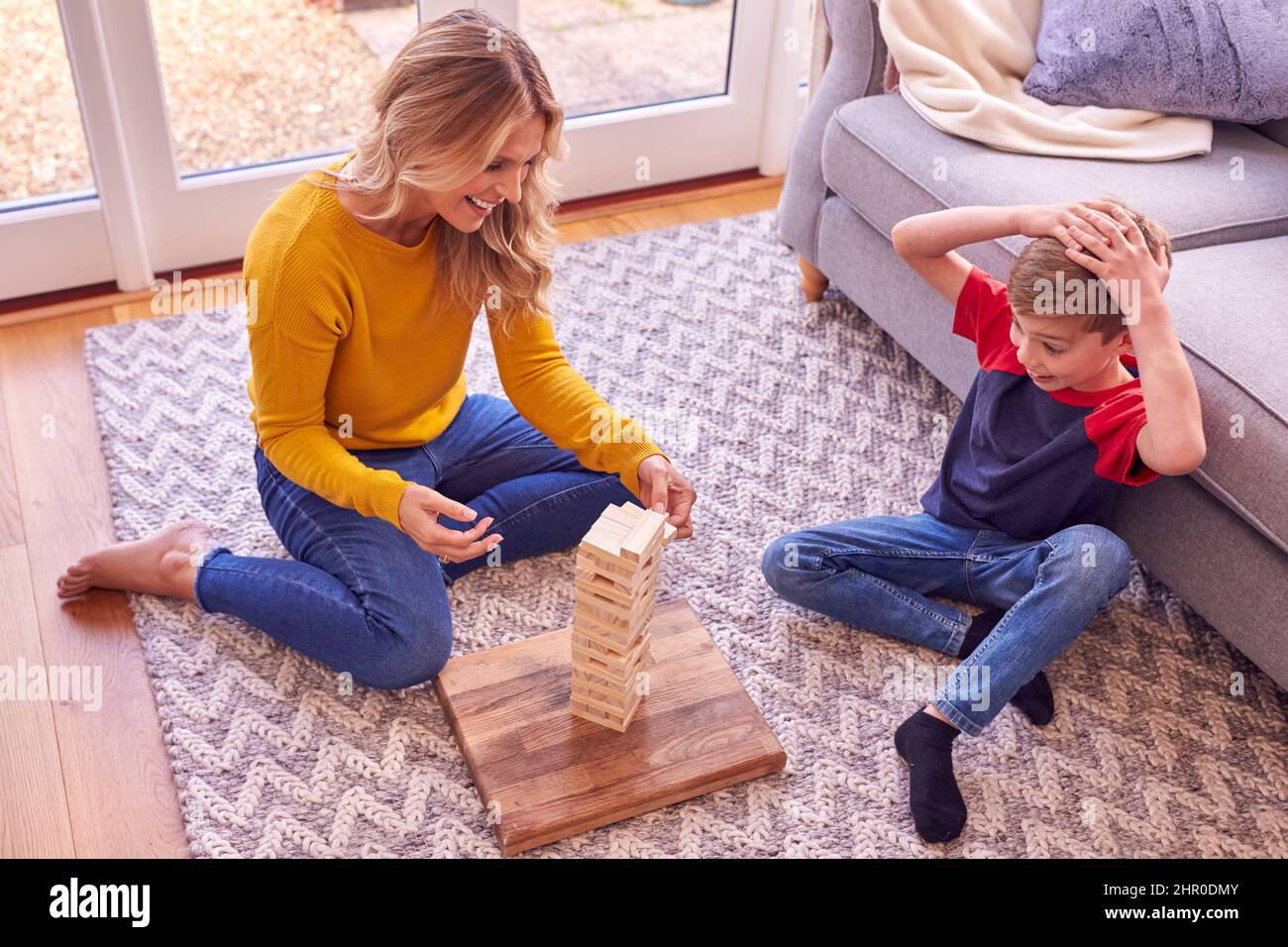 Madre e Hijo en Casa Juego Apilamiento y Equilibrio Bloques de madera juntos Foto de stock