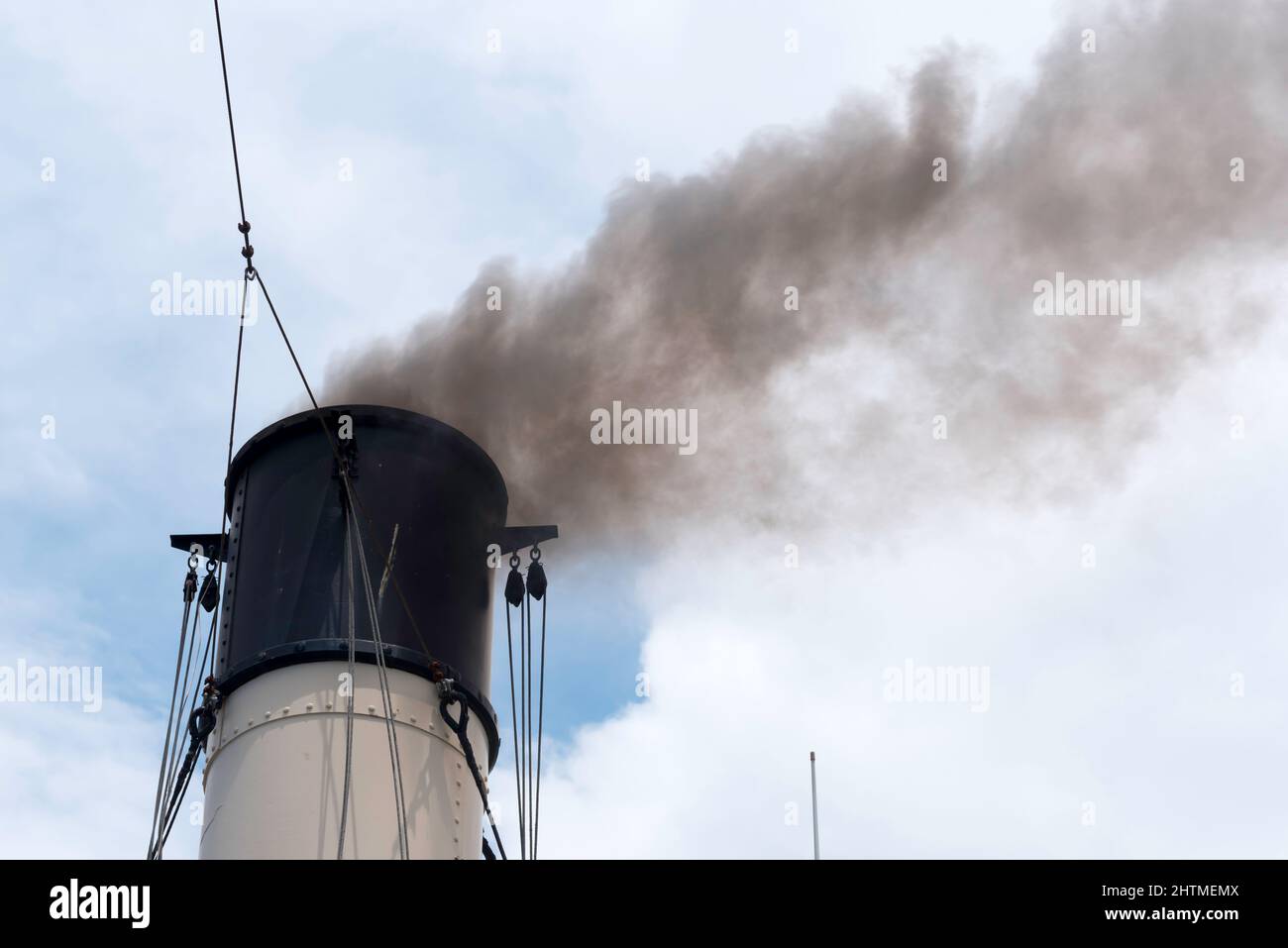 El humo de carbón negro se vierte desde el embudo del histórico remolcador de vapor de 1902 Waratah mientras navega por el puerto de Sídney en Australia Foto de stock