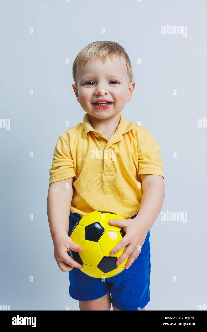 pequeño niña 3 años antiguo en un verano vestir en un claro con un amarillo  pelota en su manos. el niña es no contento 21178090 Foto de stock en  Vecteezy