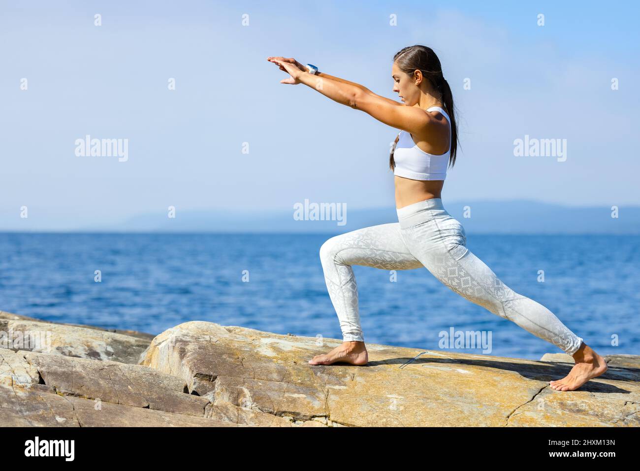 Mujer Atleta Practicando Yoga Streching Entrenamiento al aire libre por el mar Foto de stock