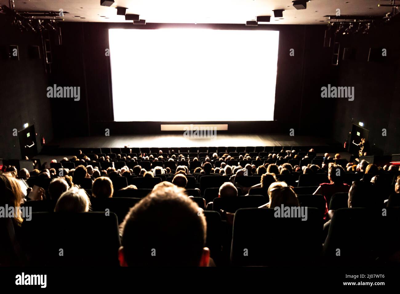 Gente en el cine viendo una película en Suiza. *** Leyenda local