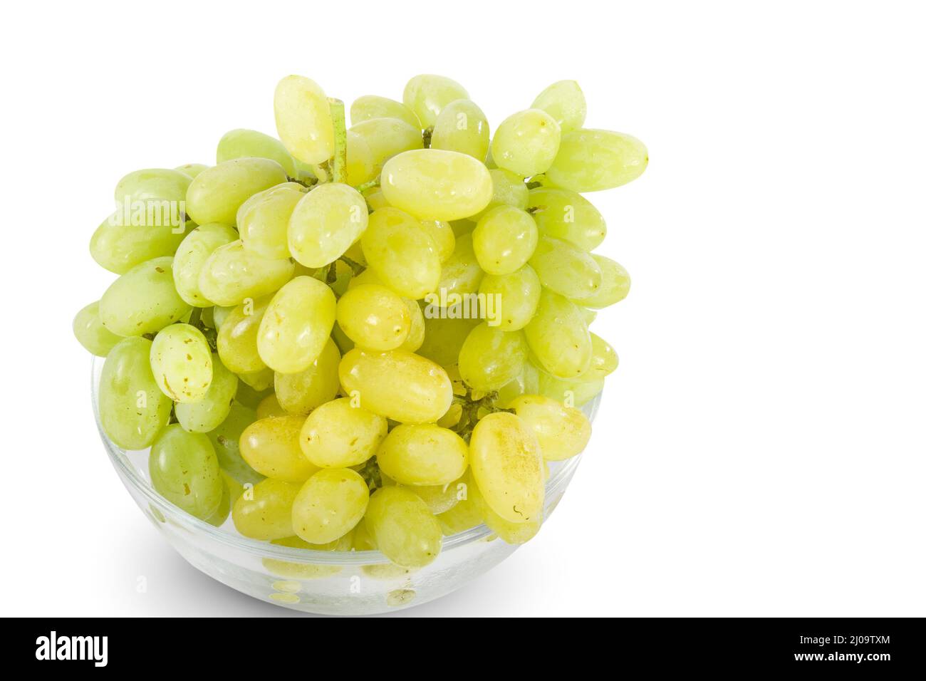 Uvas blancas en tazón de vidrio Foto de stock