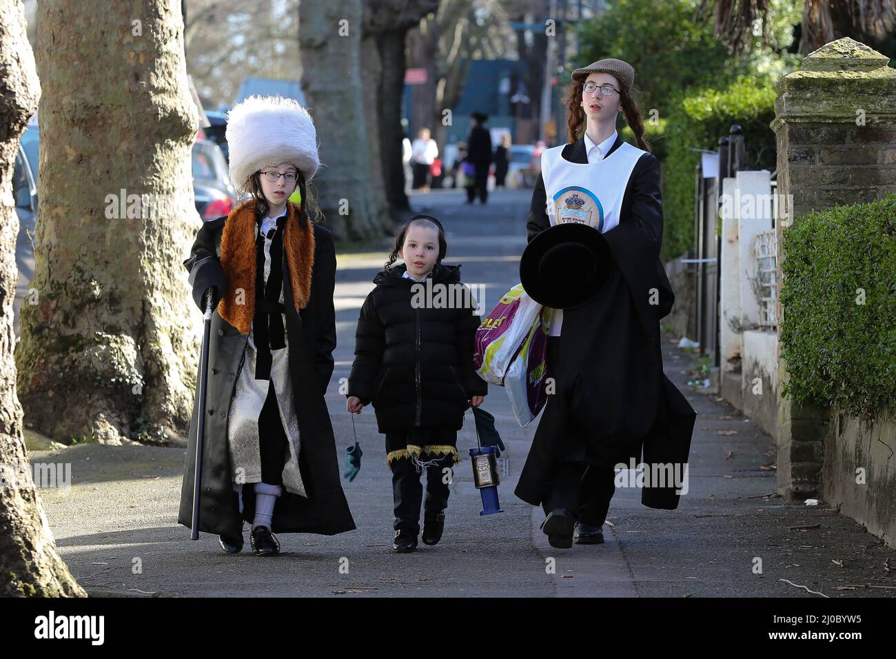 Londres, Reino Unido. 17th Mar, 2022. Los niños judíos ortodoxos vestidos con trajes participan en el festival anual de Purim en las calles de Stamford Hill, en el norte de Londres. El Londres, Reino Unido. 17th Mar, 2022. Los niños judíos ortodoxos vestidos con trajes participan en el festival anual de Purim en las calles de Stamford Hill, en el norte de Londres. El