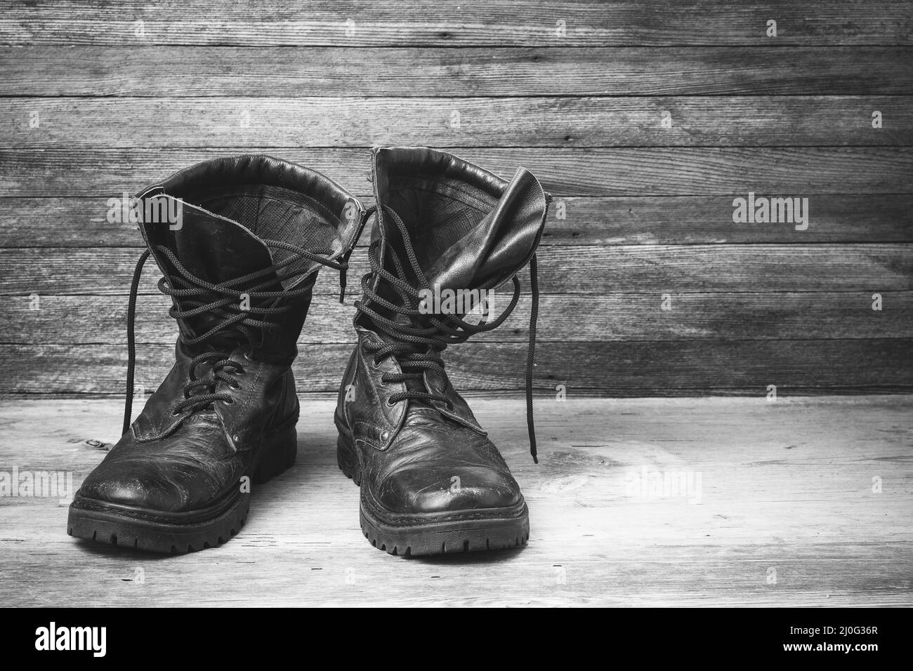 Zapatillas para hombre. Botas negras sobre fondo de madera. Primer plano  Fotografía de stock - Alamy