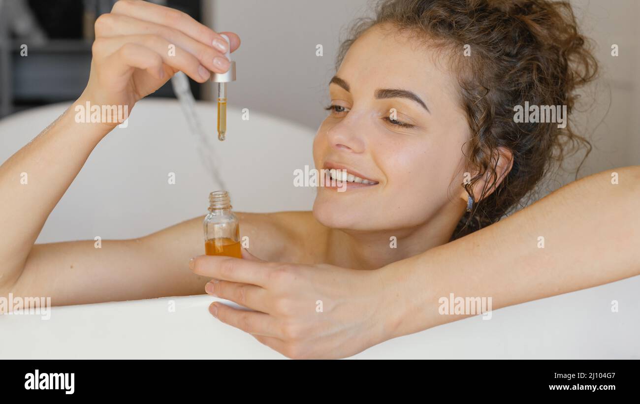 Mujer relajante bañera con suero Foto de stock