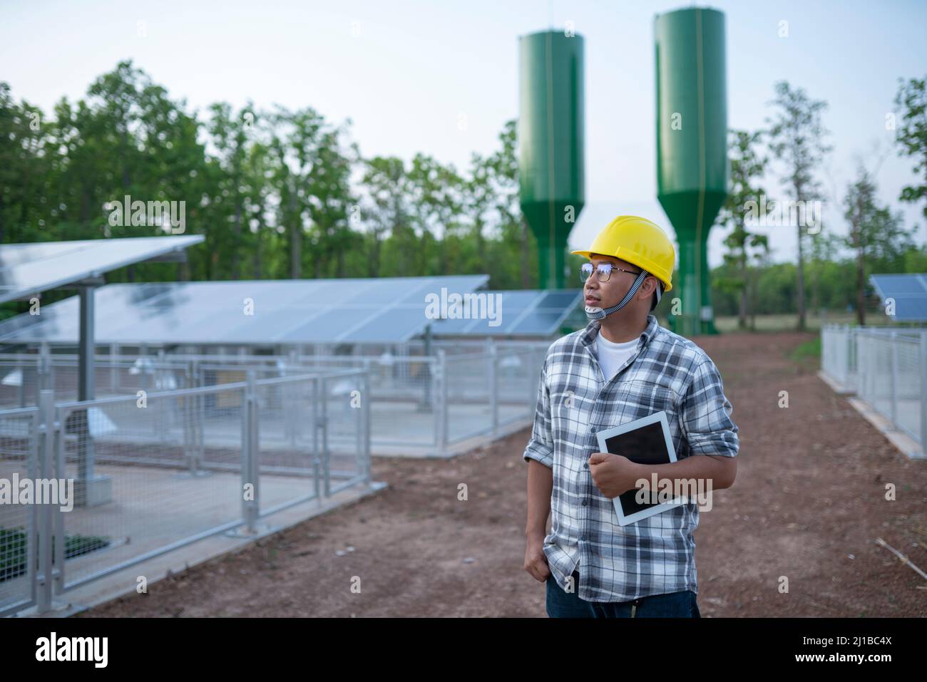 Joven técnico central solar en las tierras de labranza Foto de stock