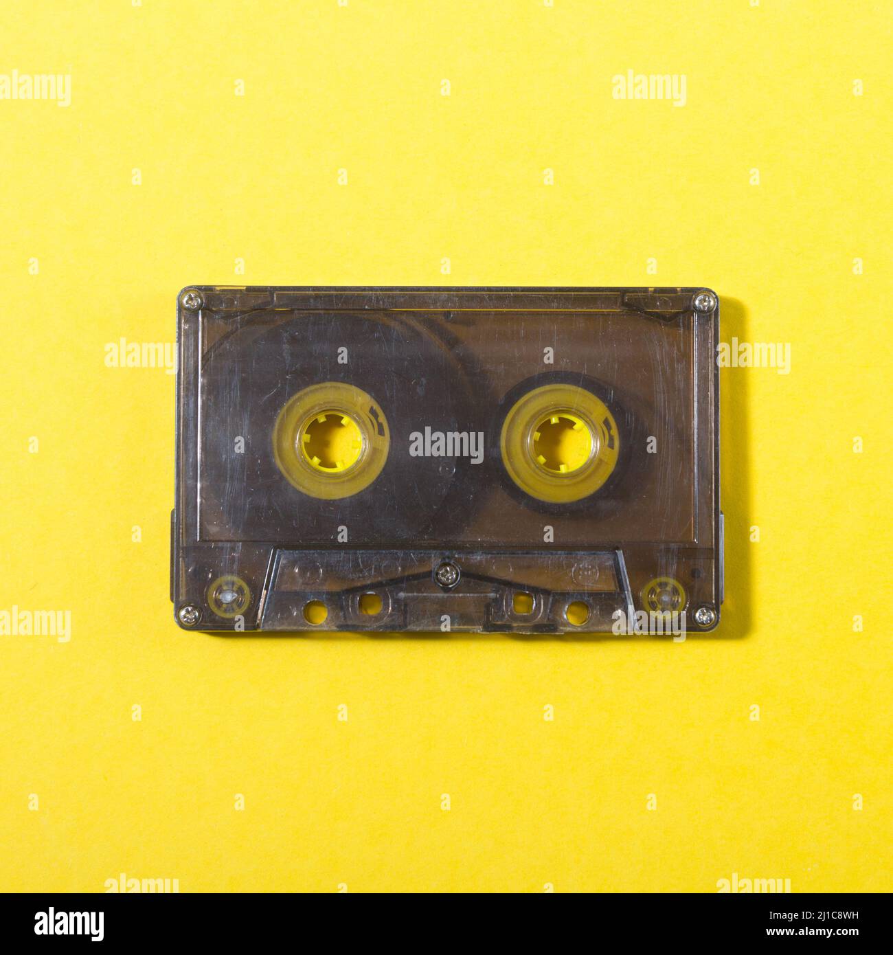 casete compacto de audio sobre fondo amarillo Foto de stock