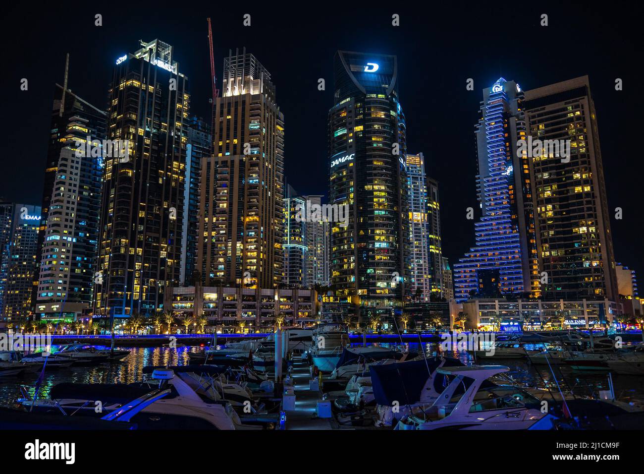 Dubai, EAU - 05 2021 dic: Vista nocturna del puerto deportivo de Dubai y sus rascacielos en construcción Foto de stock