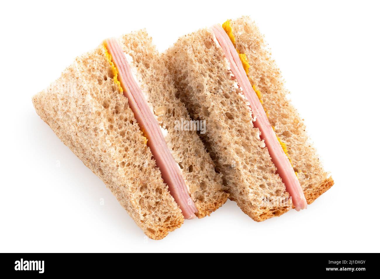 Dos sándwiches de triángulo de trigo integral de jamón y mostaza aislados sobre blanco. Foto de stock