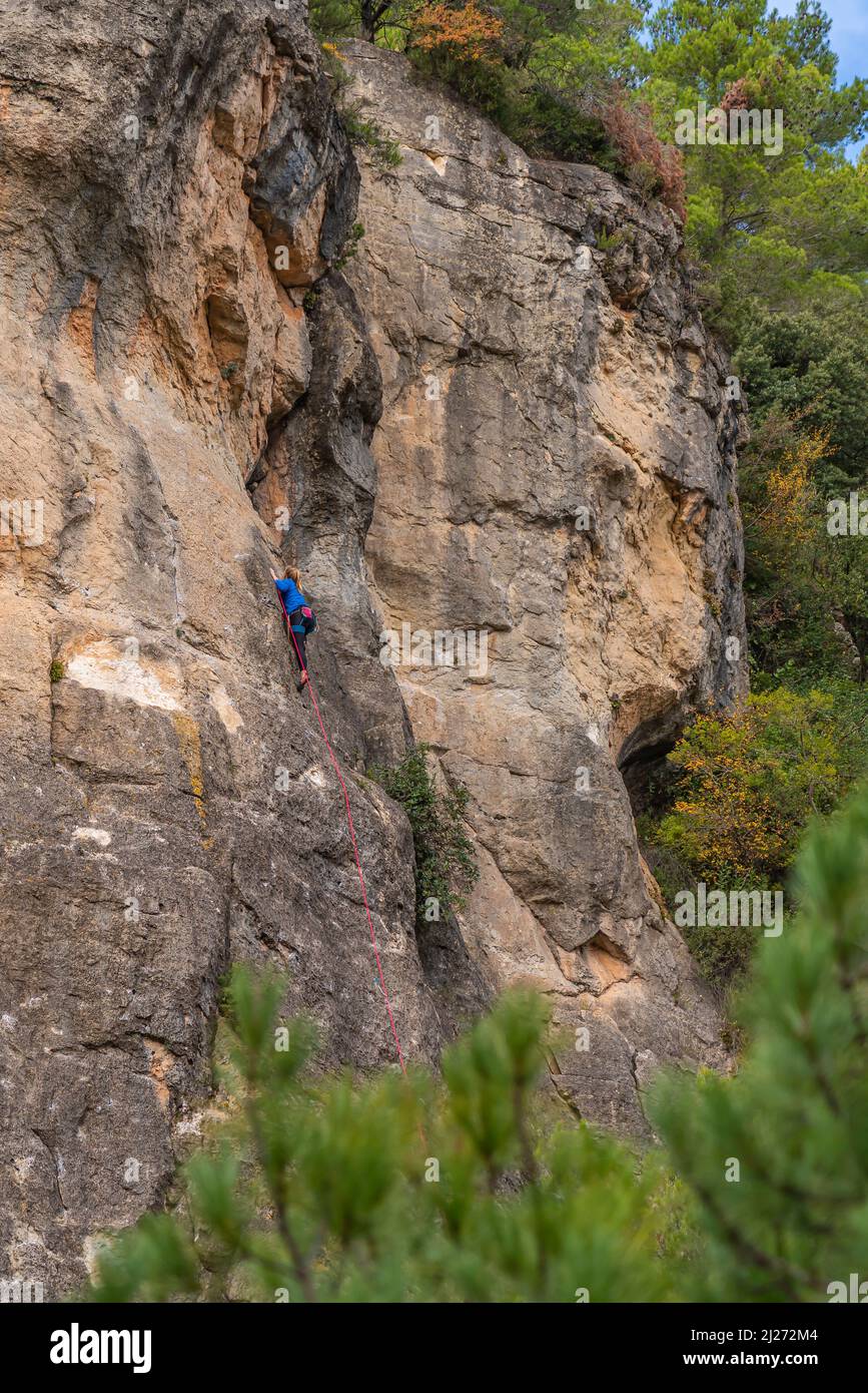 Una mujer sube a una pared de roca en Siurana. El Priorata, Cataluña, España. Foto de stock