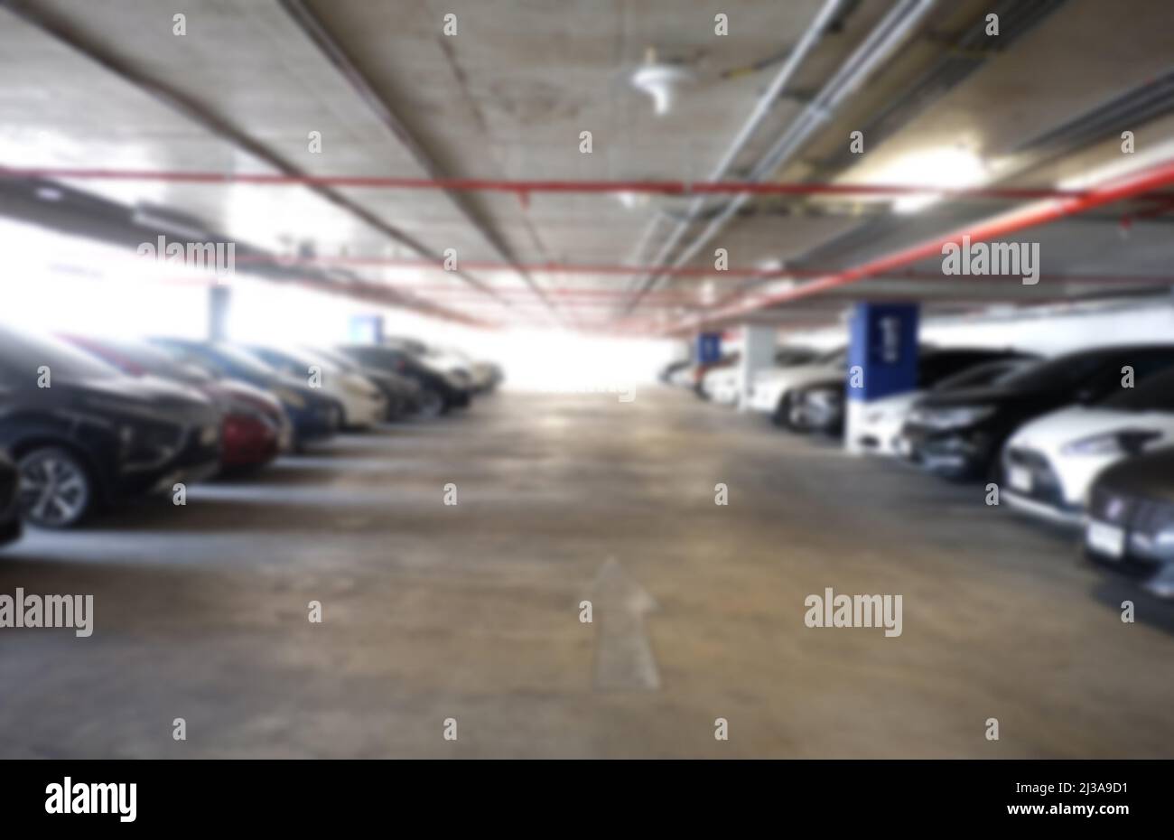 El fondo de aparcamiento para coches difuminado ofrece un diseño en tu trabajo. Foto de stock