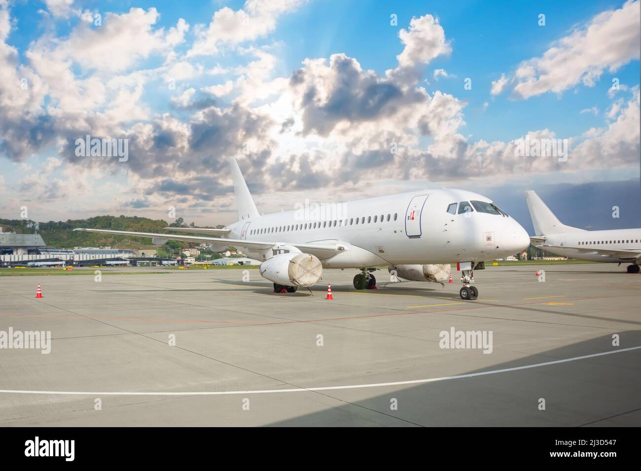 Aviones civiles de pasajeros estacionados al aire libre en el aeropuerto con motores cerrados en tapas Foto de stock