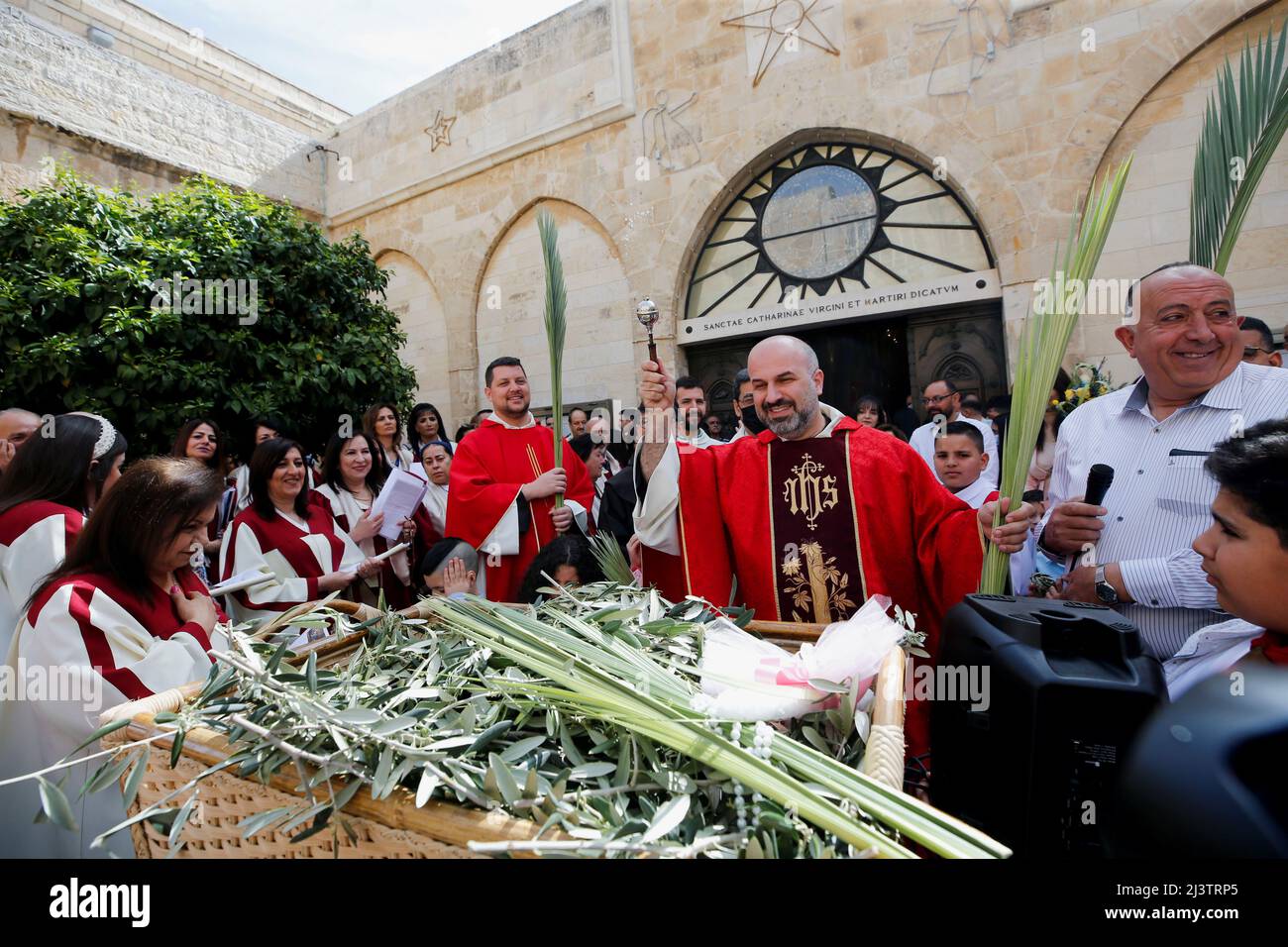 El Padre Rami Asakriyah roció agua santa sobre las palmas durante el  servicio del Domingo de Ramos en la Iglesia de la Natividad en Belén, en la  Ribera Occidental ocupada por Israel,