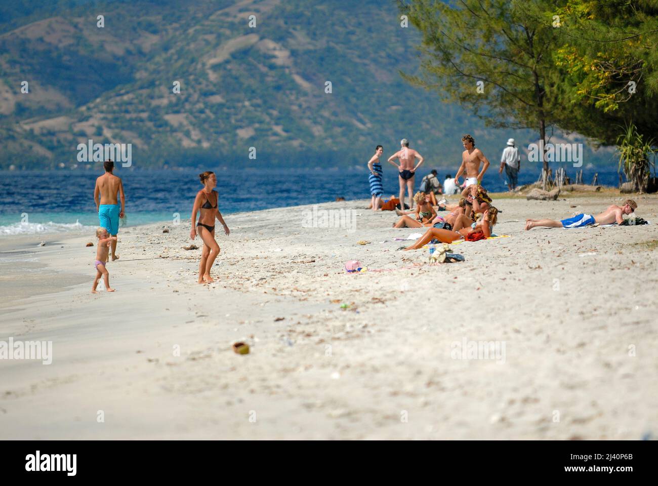 Los turistas nadan y se relajan en una de las playas de Gili Trawangan. Foto de stock