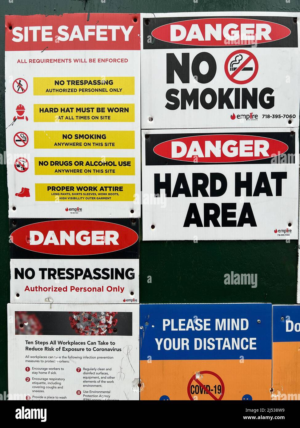 Señales de advertencia y peligro colocadas en una pared de construcción