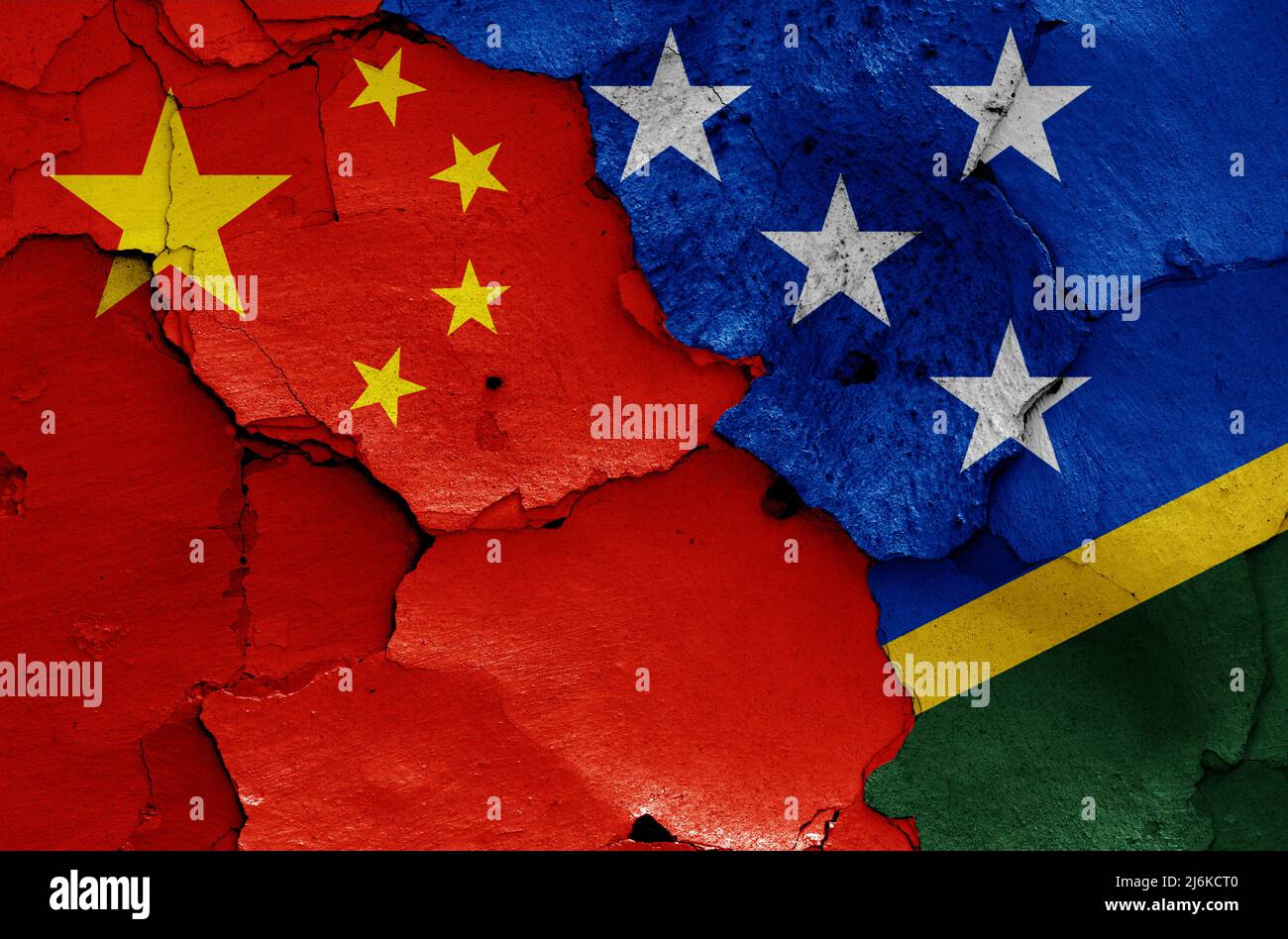 Banderas de China e Islas Salomón pintadas en la pared agrietada Foto de stock