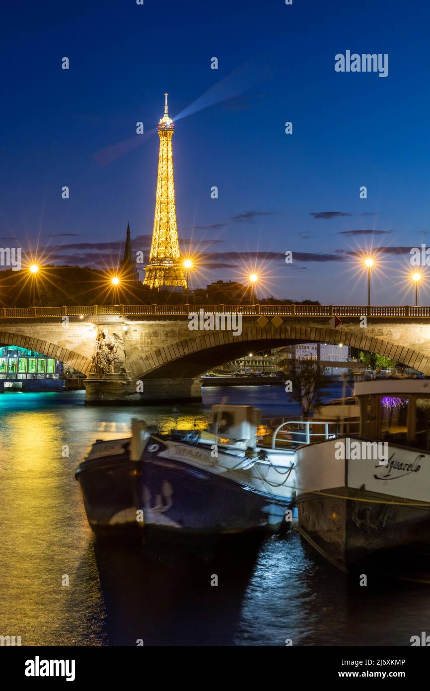 Barcazas a lo largo del río sena por debajo de la Torre Eiffel, París, Francia Foto de stock