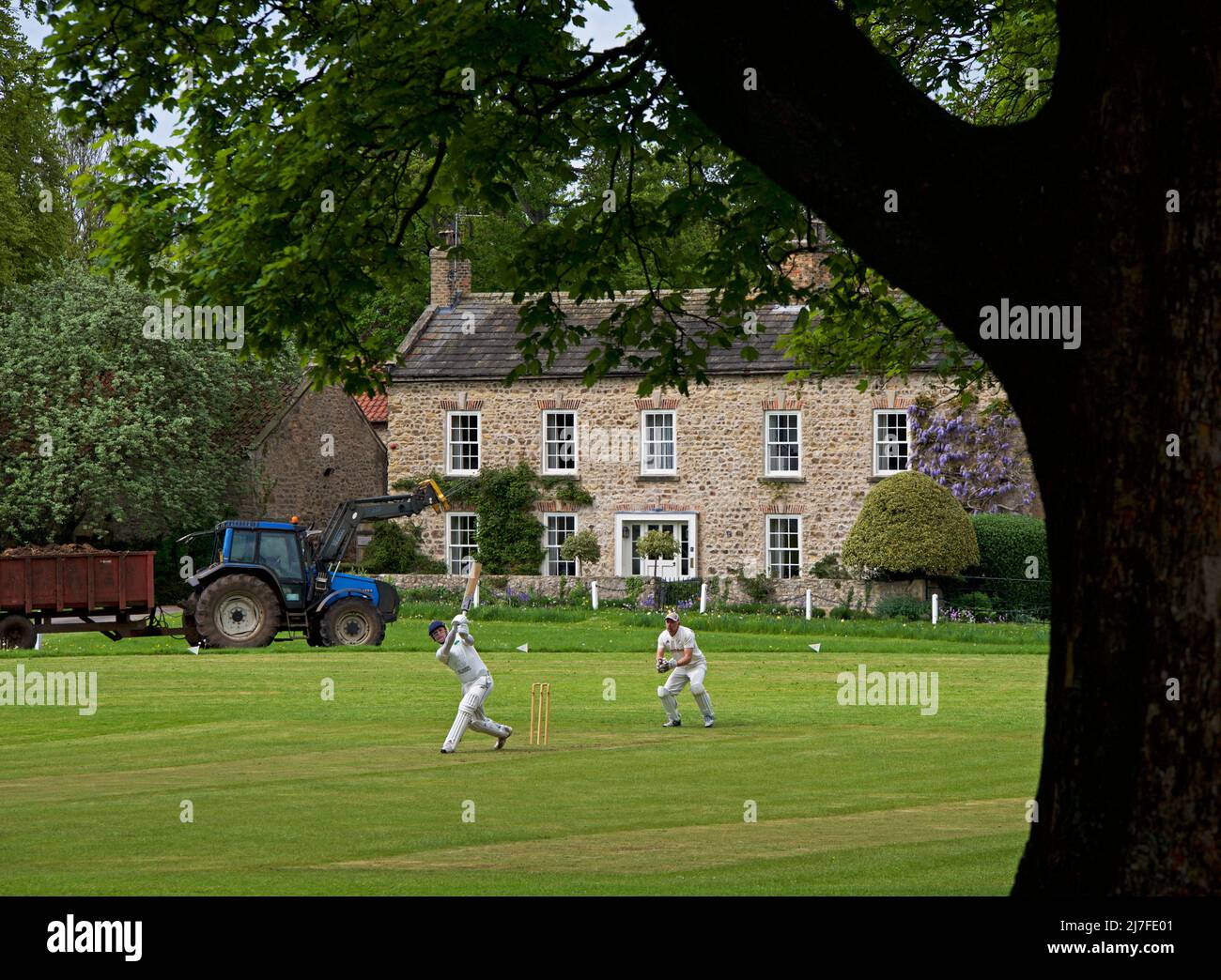 Partido de críquet en curso en el pueblo de Crakehall, North Yorkshire, Inglaterra Reino Unido Foto de stock