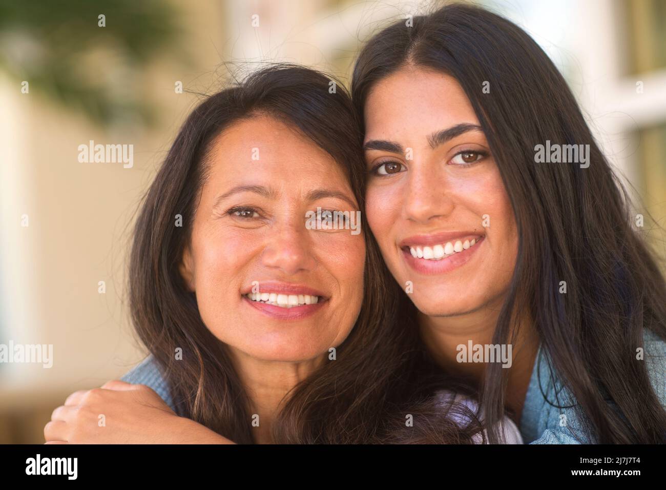 Madre y su hija adulta abrazando y riendo Foto de stock