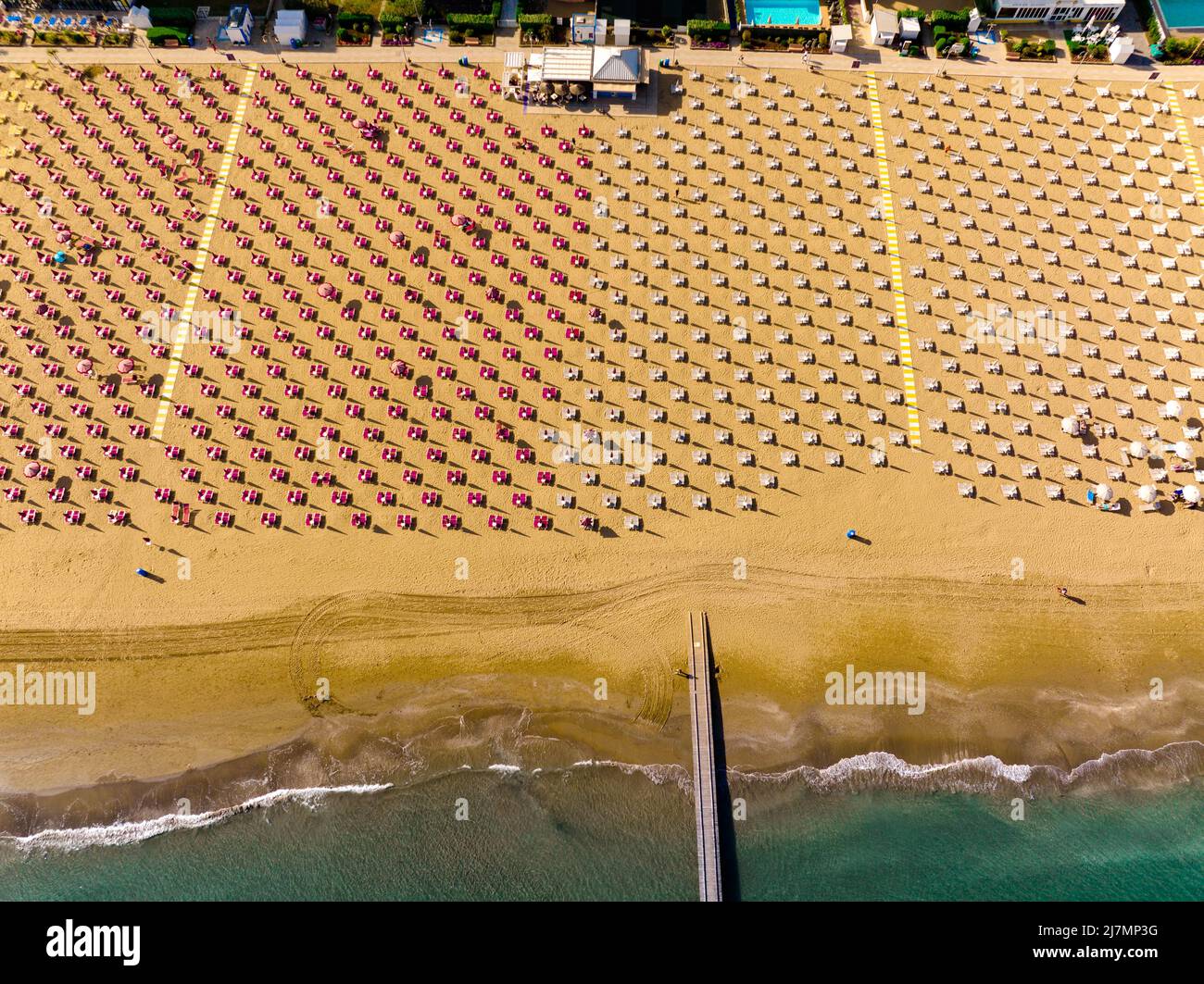 Playa Jesolo con hamacas, tumbonas y sombrillas en el lido marítimo visto desde arriba - vacaciones de verano en ciudades italianas Foto de stock