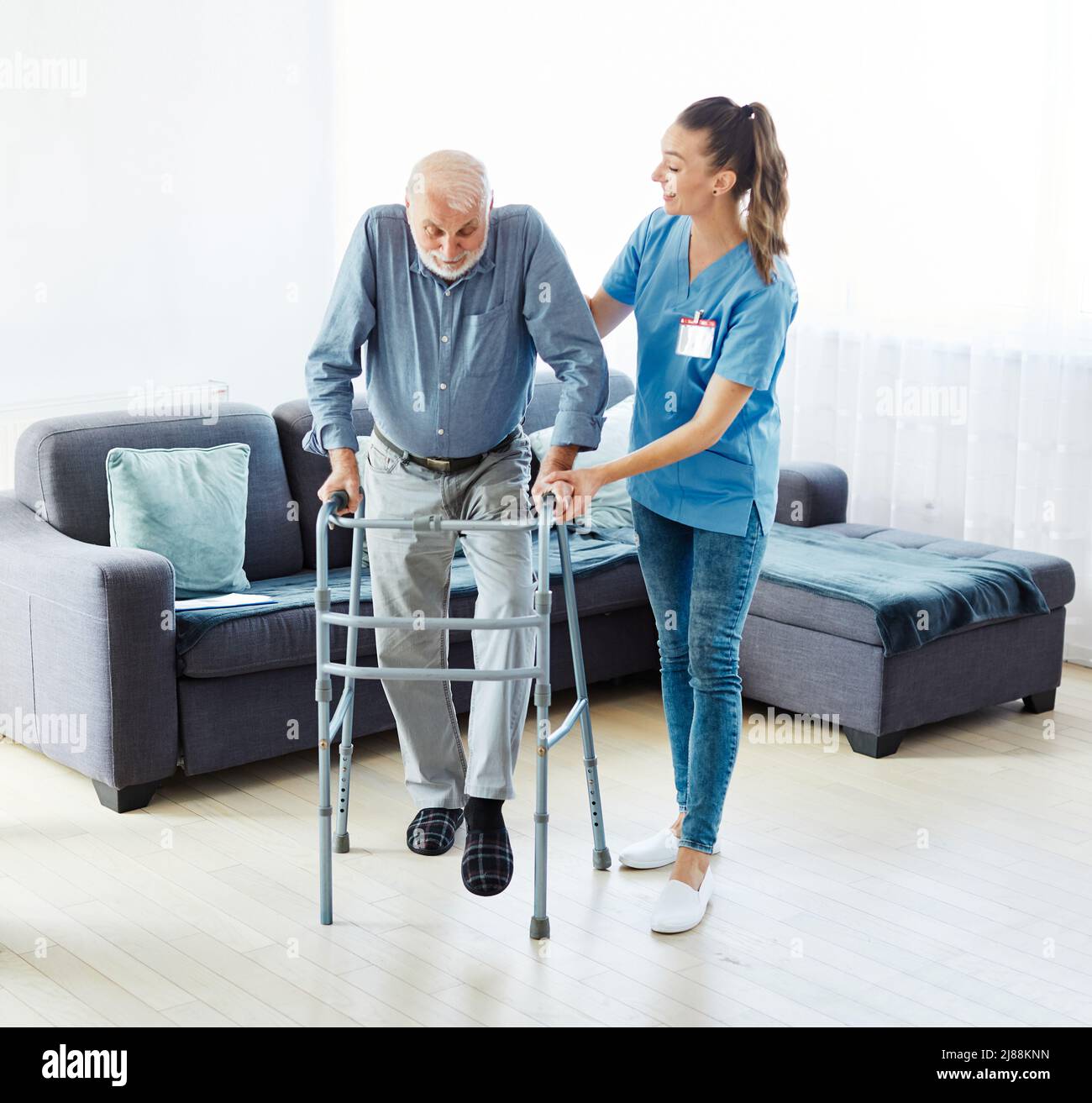 enfermero médico cuidador mayor ayuda a caminante asisistencia retiro hogar ancianos hombre Foto de stock