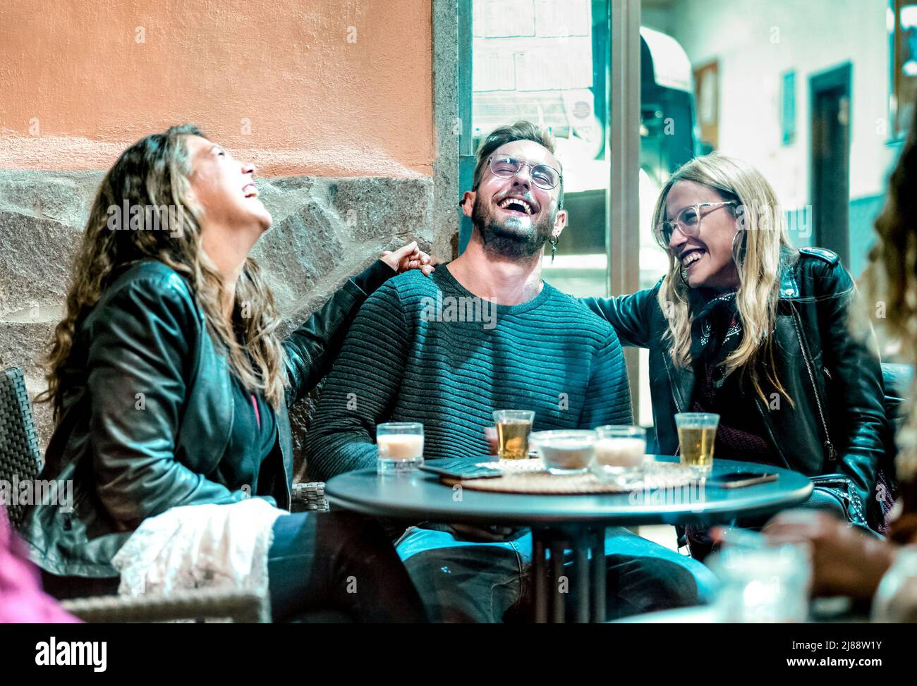 Amigos jóvenes Diviértete bebiendo en la hora feliz en el bar de la calle - Gente millenial riendo y pasando tiempo juntos - Estilo de vida de la amistad CO Foto de stock