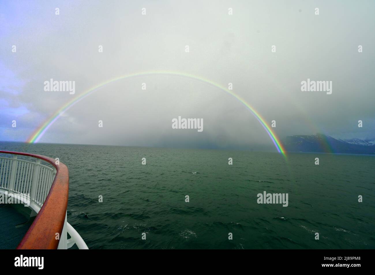 ganzer, im Meer versinkender bunter Regenbogen vom Schiff aus gesehen Foto de stock