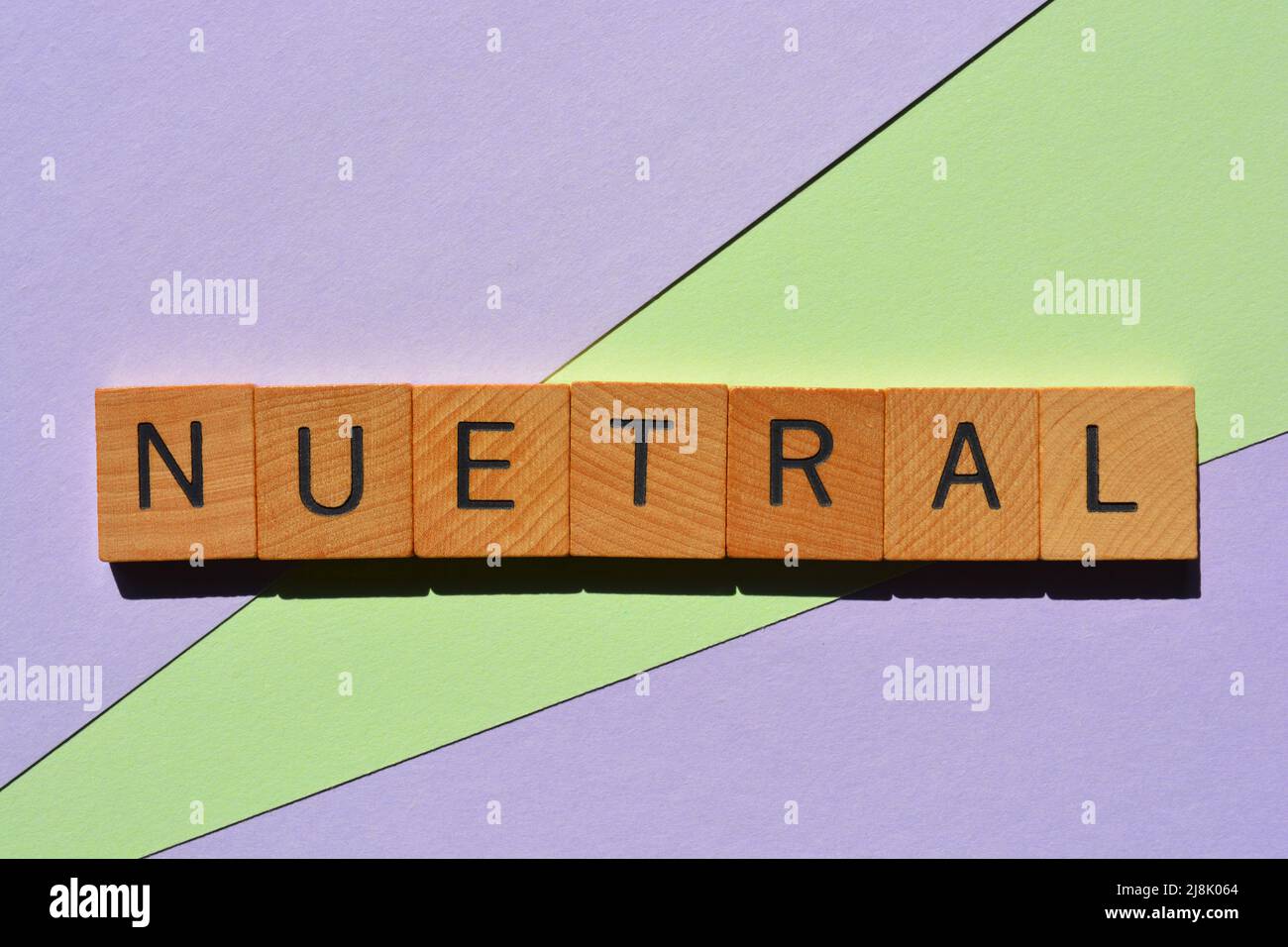 Neutral, palabra en letras del alfabeto de madera aisladas sobre fondo de color pastel Foto de stock