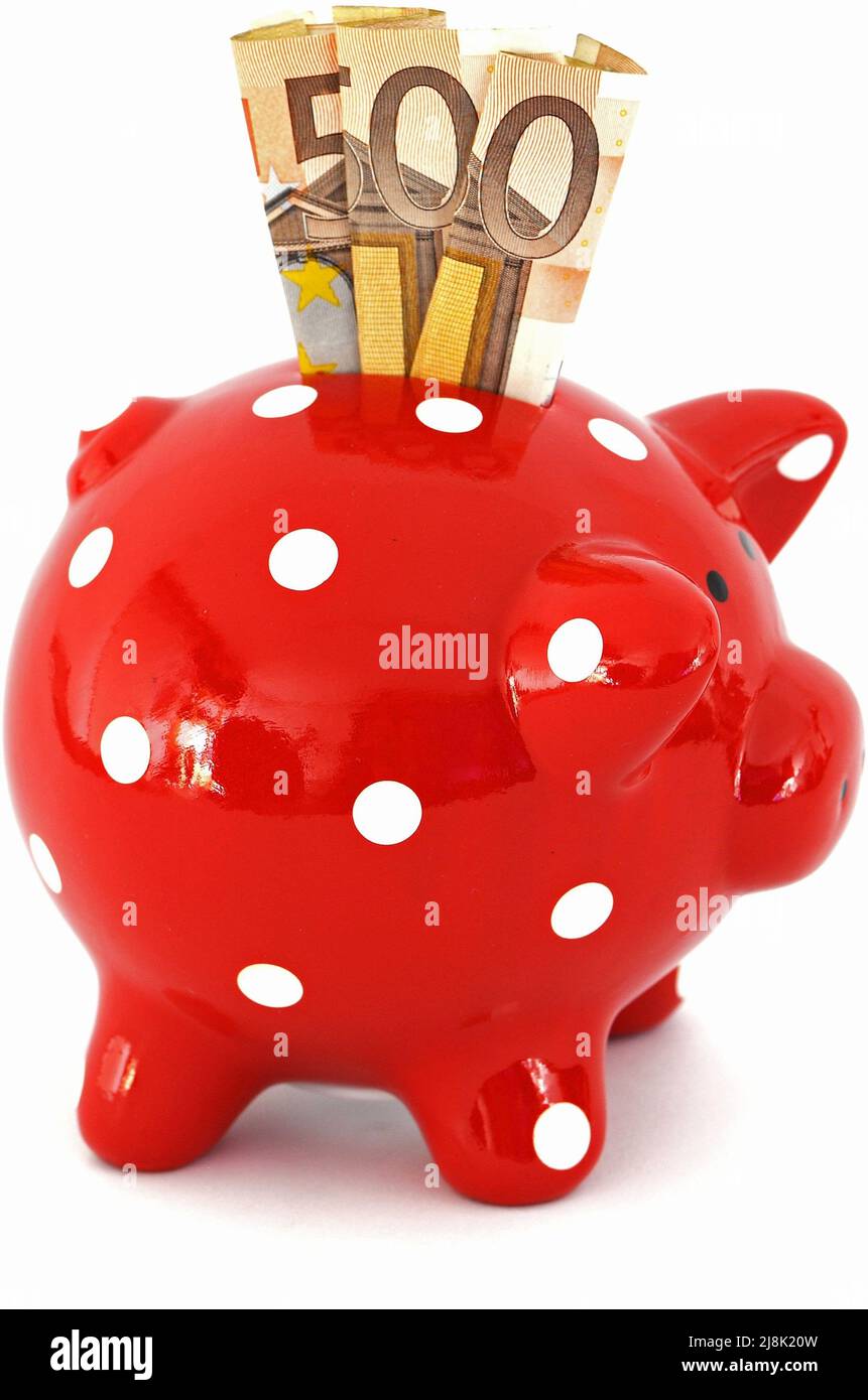 Piggybank rojo con puntos blancos con billetes de 50 euros Foto de stock