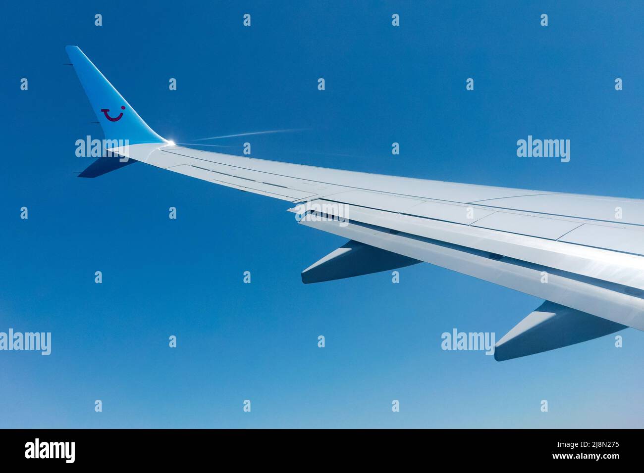 Un ala de un avión TUI que se muestra en el vuelo con una vista de pasajero desde la cabina de los aviones. El logotipo de la empresa TUI se muestra claramente en el winglet de ala de alas Foto de stock