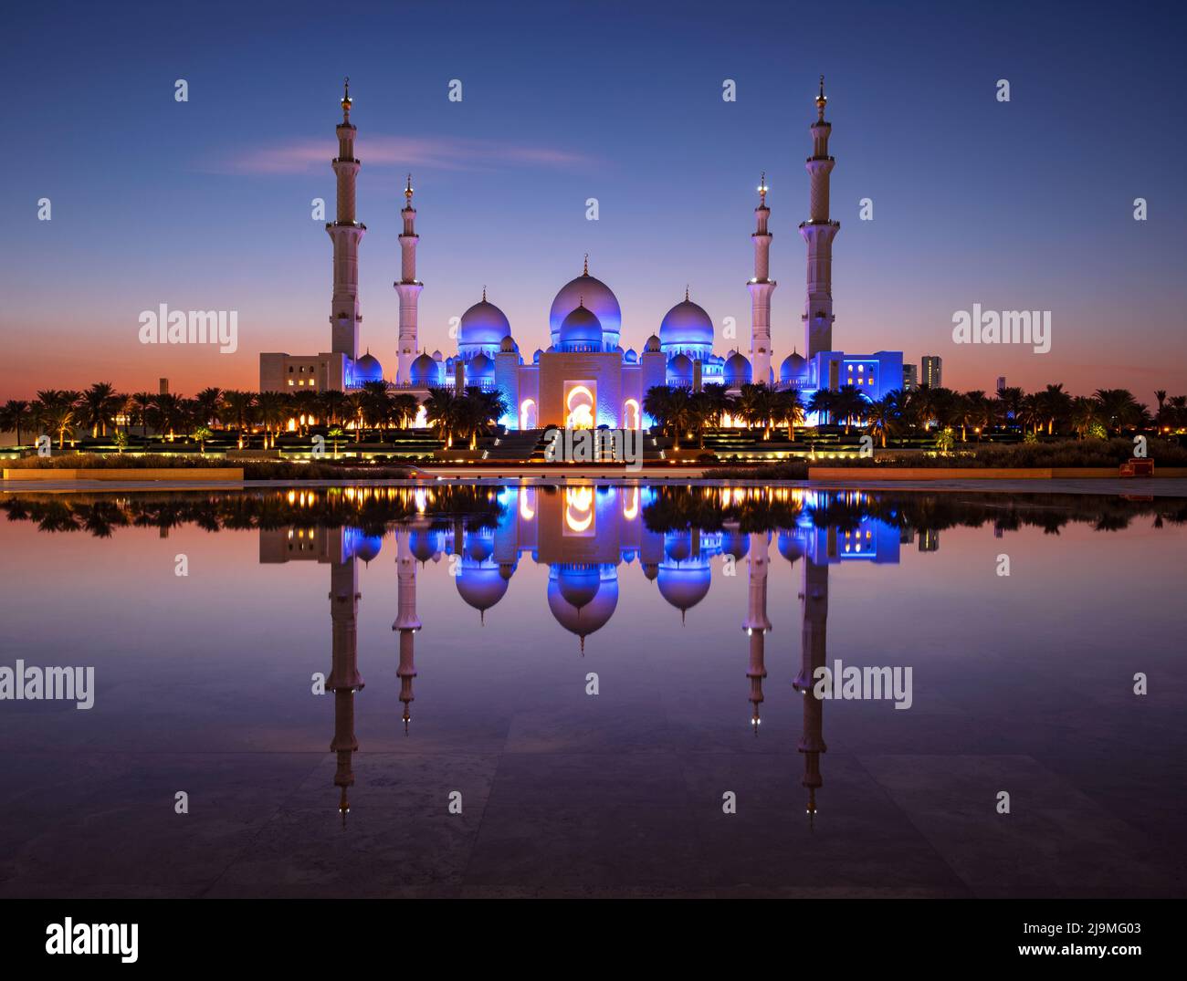 Vista de la Gran Mezquita Sheikh Zayed, la mezquita más grande de los Emiratos Árabes Unidos capturada durante la hora azul de Wahat al Karama, Abu Dhabi. Foto de stock