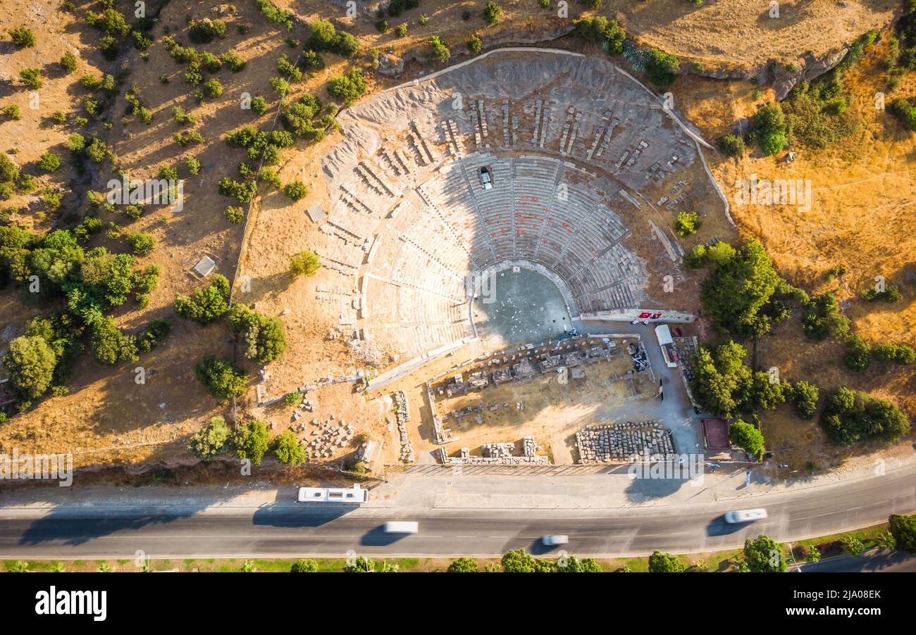 Arriba Vista aérea de lugares históricos, ruinas de teatro, enorme teatro antiguo de Halicarnaso con la carretera que cruza la ciudad Bodrum, Turquía Foto de stock