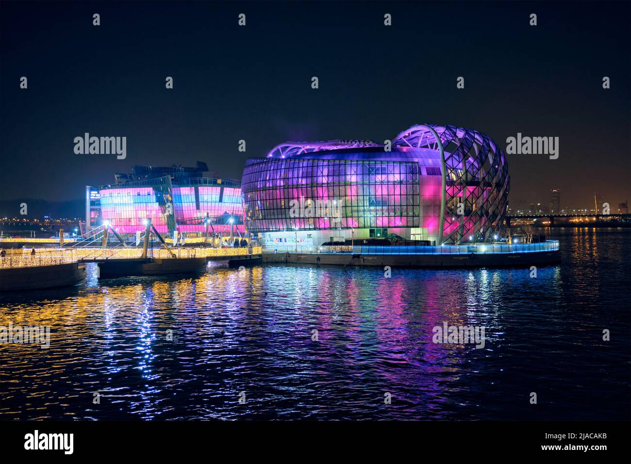 Algunos edificios sevicios en islas flotantes artificiales situadas cerca del puente de Banpo iluminados por la noche, Seúl, Corea del Sur Foto de stock
