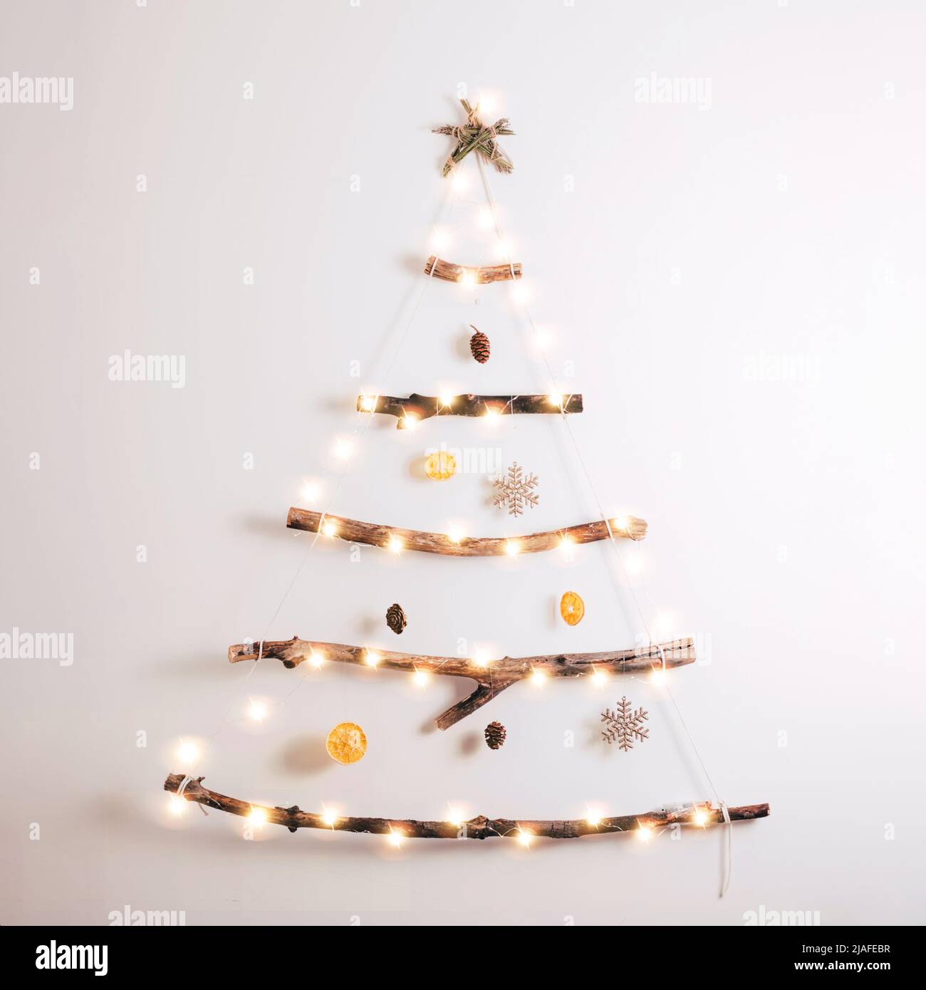futuro Superior Memorizar Árbol de Navidad de estilo minimalista hecho de palos secos, naranja seco,  conos sobre fondo blanco. Navidad sin residuos, Año Nuevo, concepto  ecológico Fotografía de stock - Alamy