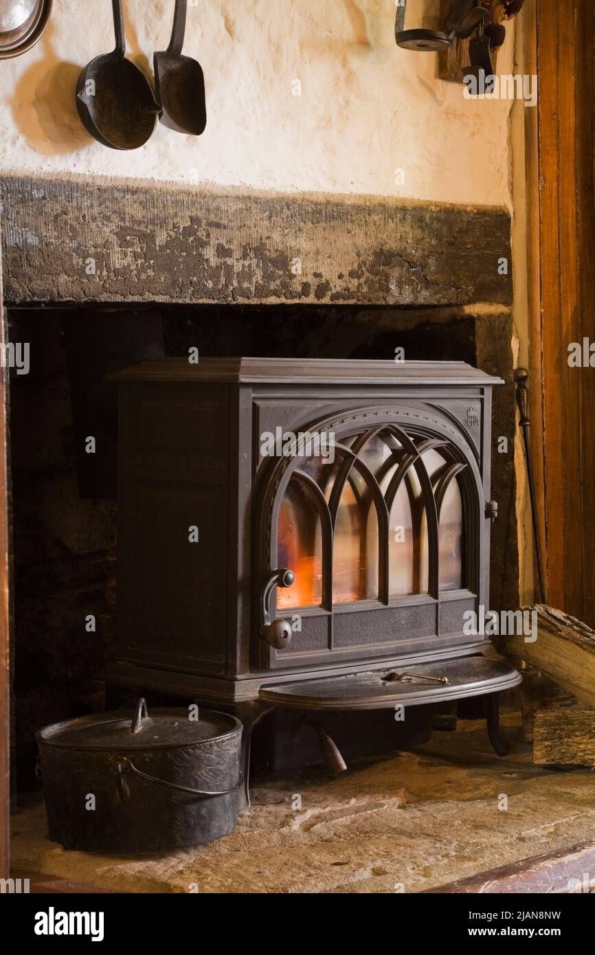 Estufa a leña de hierro fundido negro en el hogar de la chimenea en la  cocina dentro de la antigua casa de campo estilo rural de alrededor de 1840  Canadiana Fotografía de