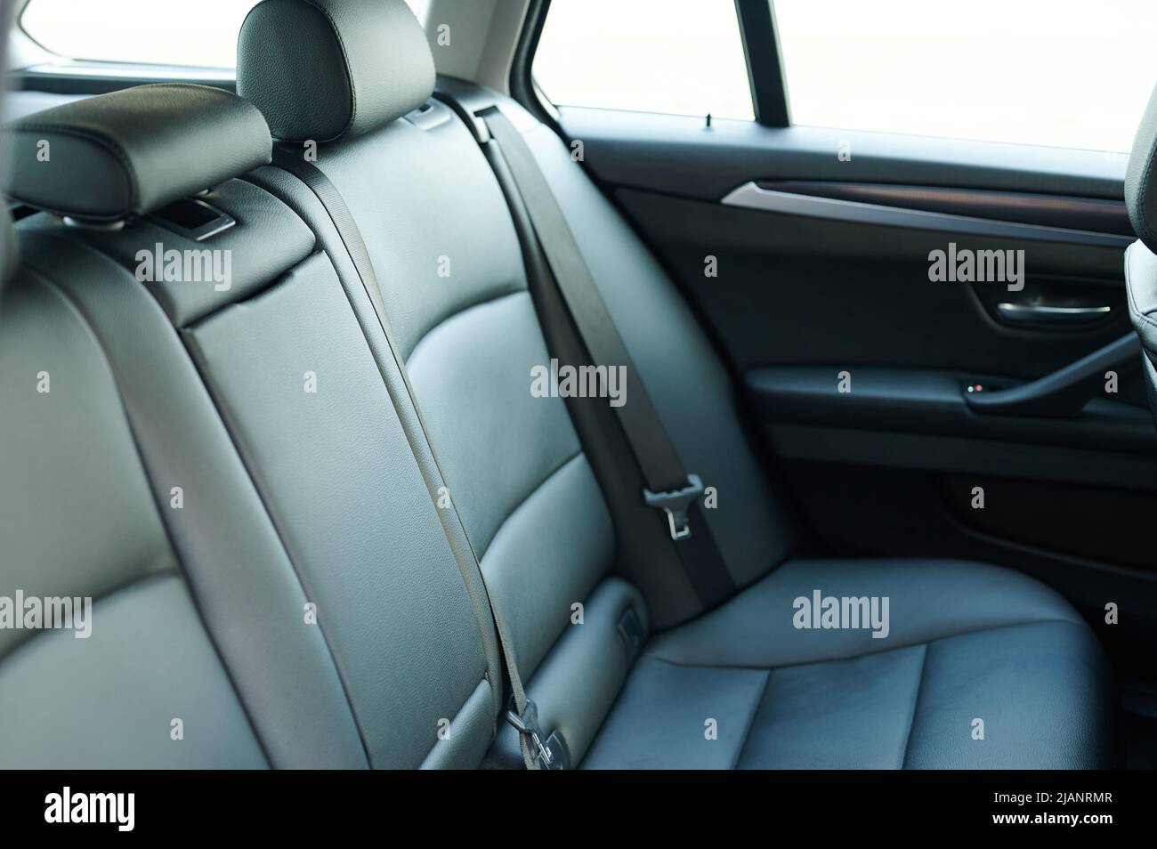 Asiento de cuero para el coche con cinturón de seguridad aislado en el fondo del estudio Foto de stock