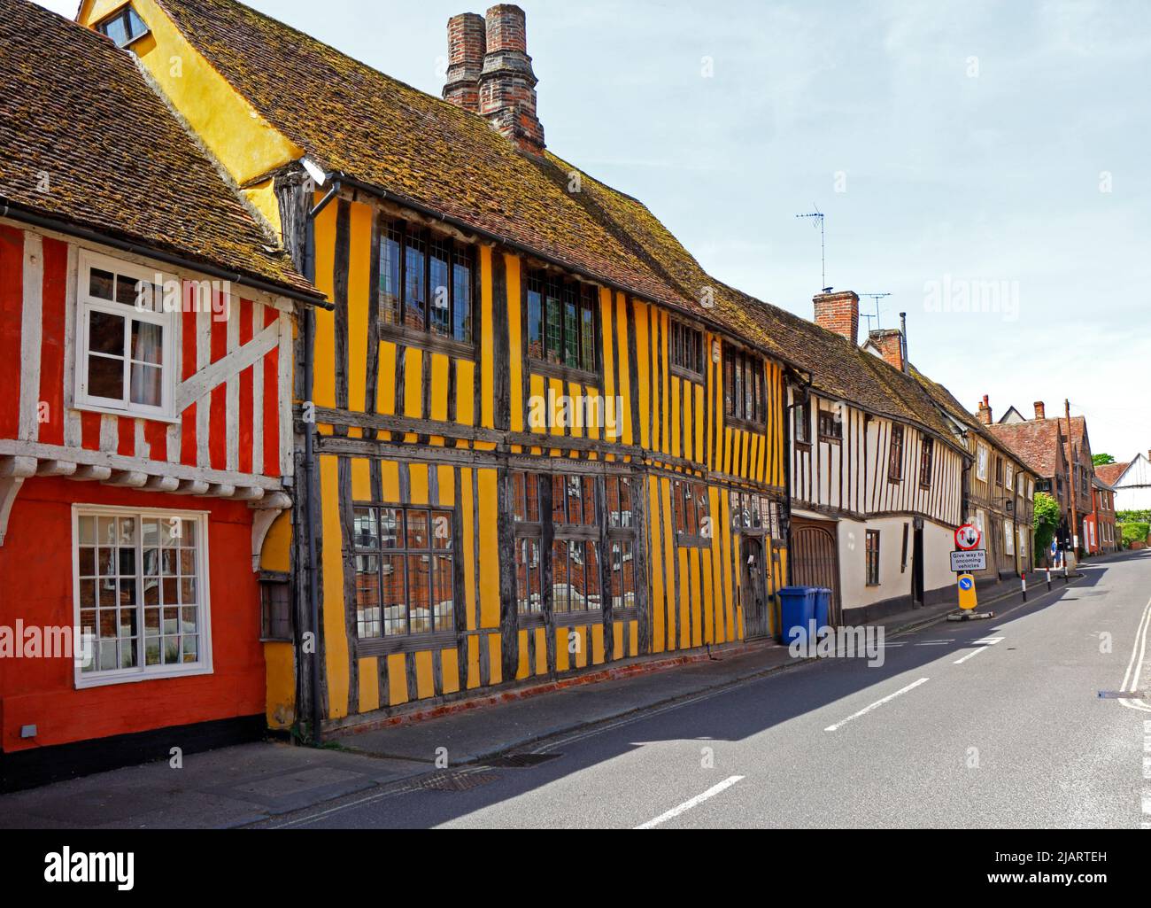 Una calle de coloridas casas medievales bien conservadas con entramado de madera en el pintoresco pueblo de Lavenham, Suffolk, Inglaterra, Reino Unido. Foto de stock