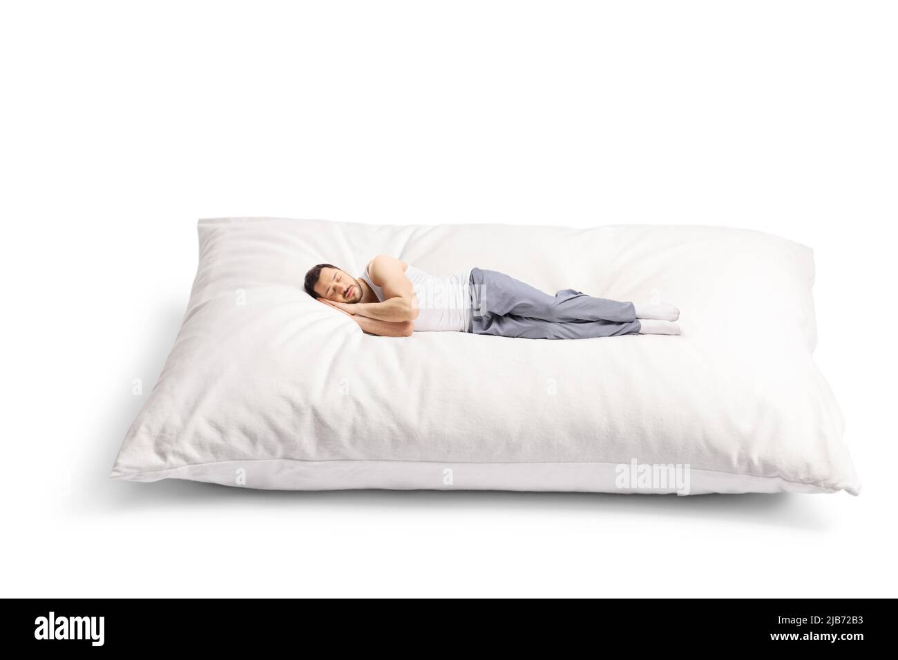 Hombre joven durmiendo en una almohada grande de comfortbale aislada sobre  fondo blanco Fotografía de stock - Alamy