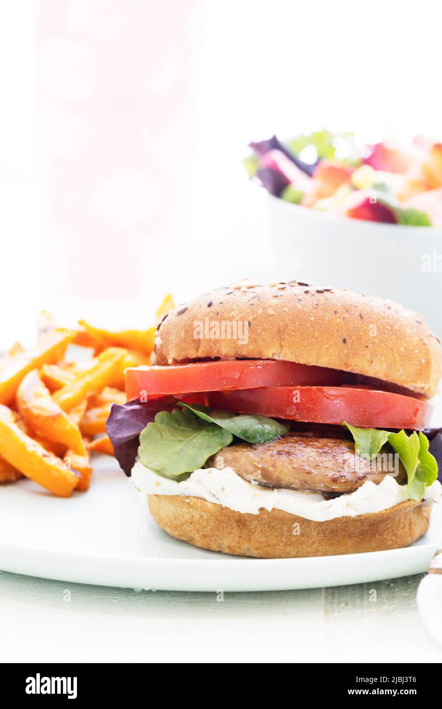 Hamburguesa de champiñones portobello a la parrilla en bollo de trigo integral con patatas