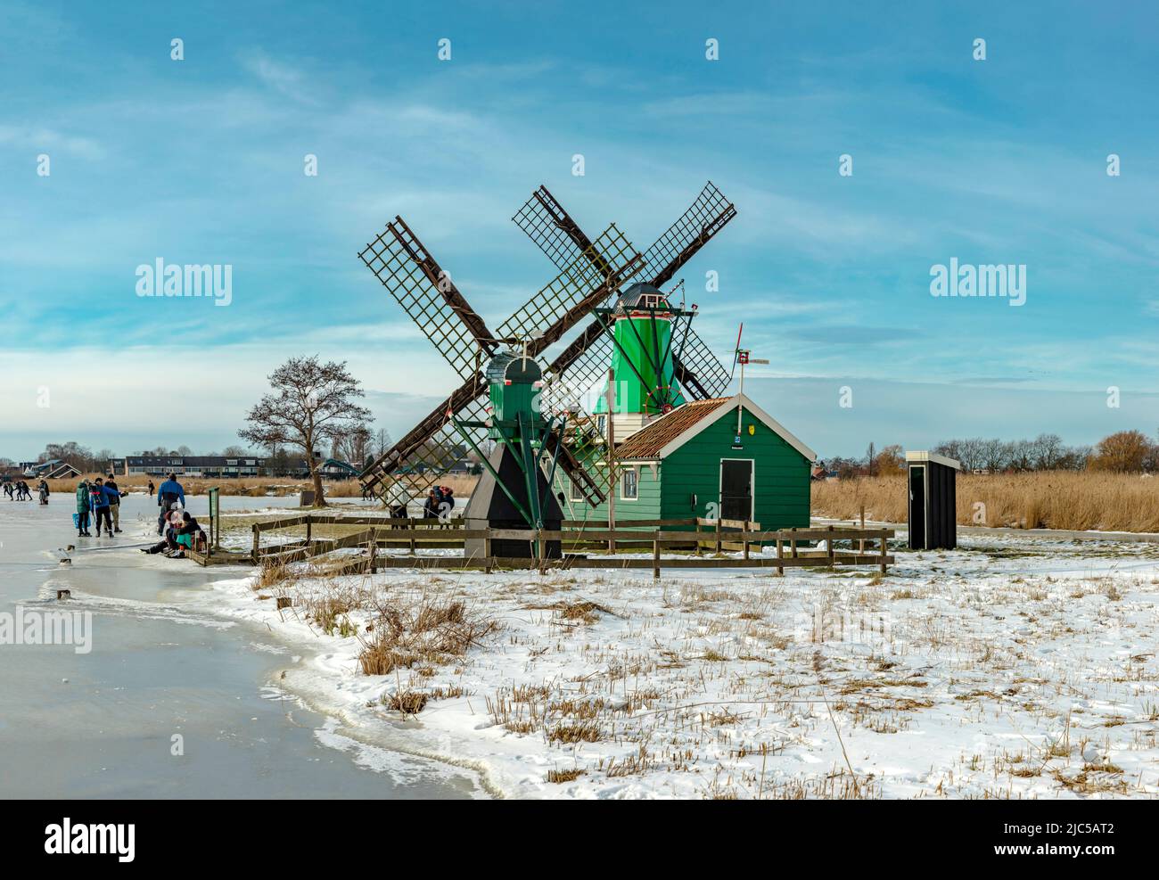 Scating en un canal congelado cerca de un molino de viento llamado De Jonge Dirk *** Local Caption *** Países Bajos,molino de viento, campo, prado, agua, invierno, nieve, hielo, Foto de stock