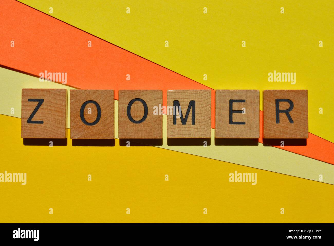 Zoomer, palabra en letras del alfabeto de madera aislada sobre fondo brillante y colorido Foto de stock