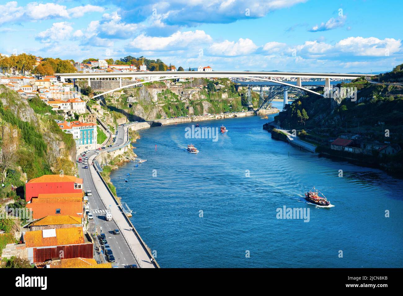 Horizonte soleado, barcos turísticos con vista al río Douro, Ponte Infante Dom Henrique, Porto, Portugal Foto de stock