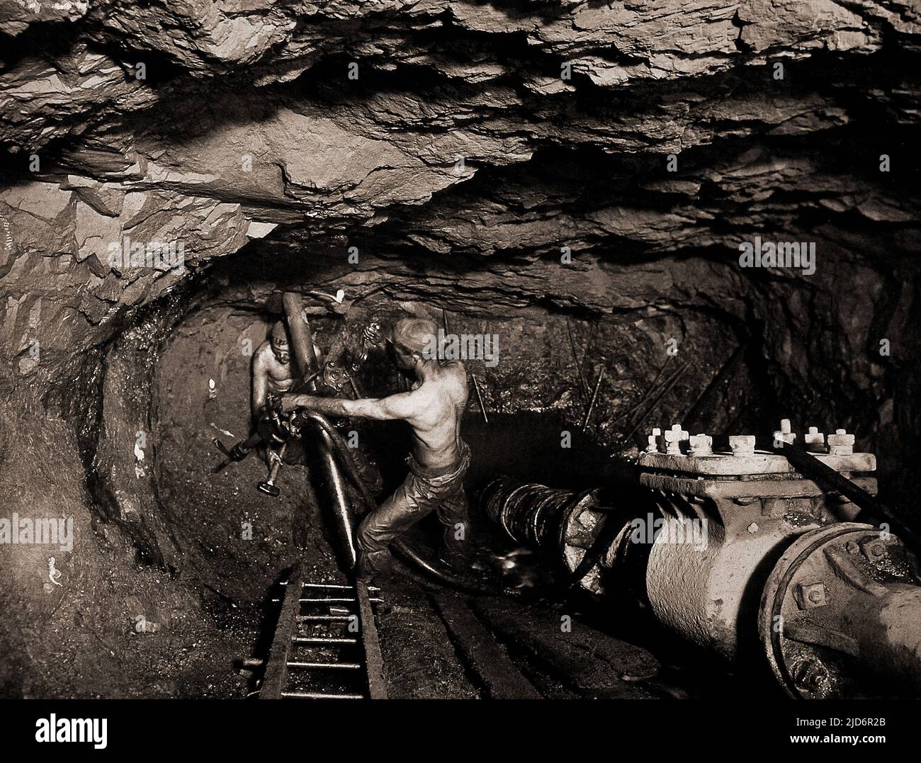 Minería de estaño en la mina Tincroft, Carn Brea, una mina de Cornualles en 1910, fotografía de J.C. Burrow, observe las velas pegadas a la pared para la iluminación Foto de stock