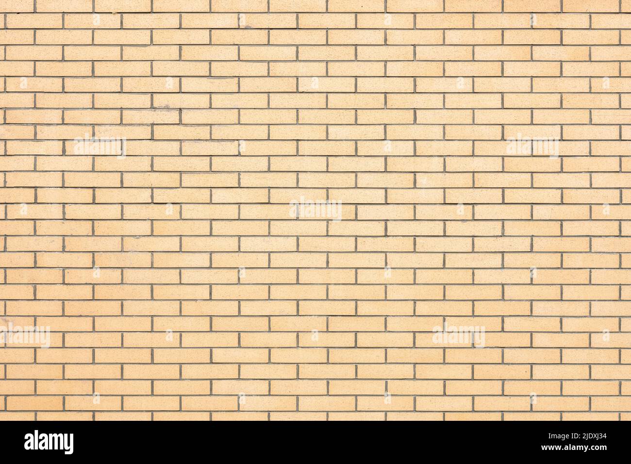 pared de ladrillo amarillo en formato cuadrado Foto de stock