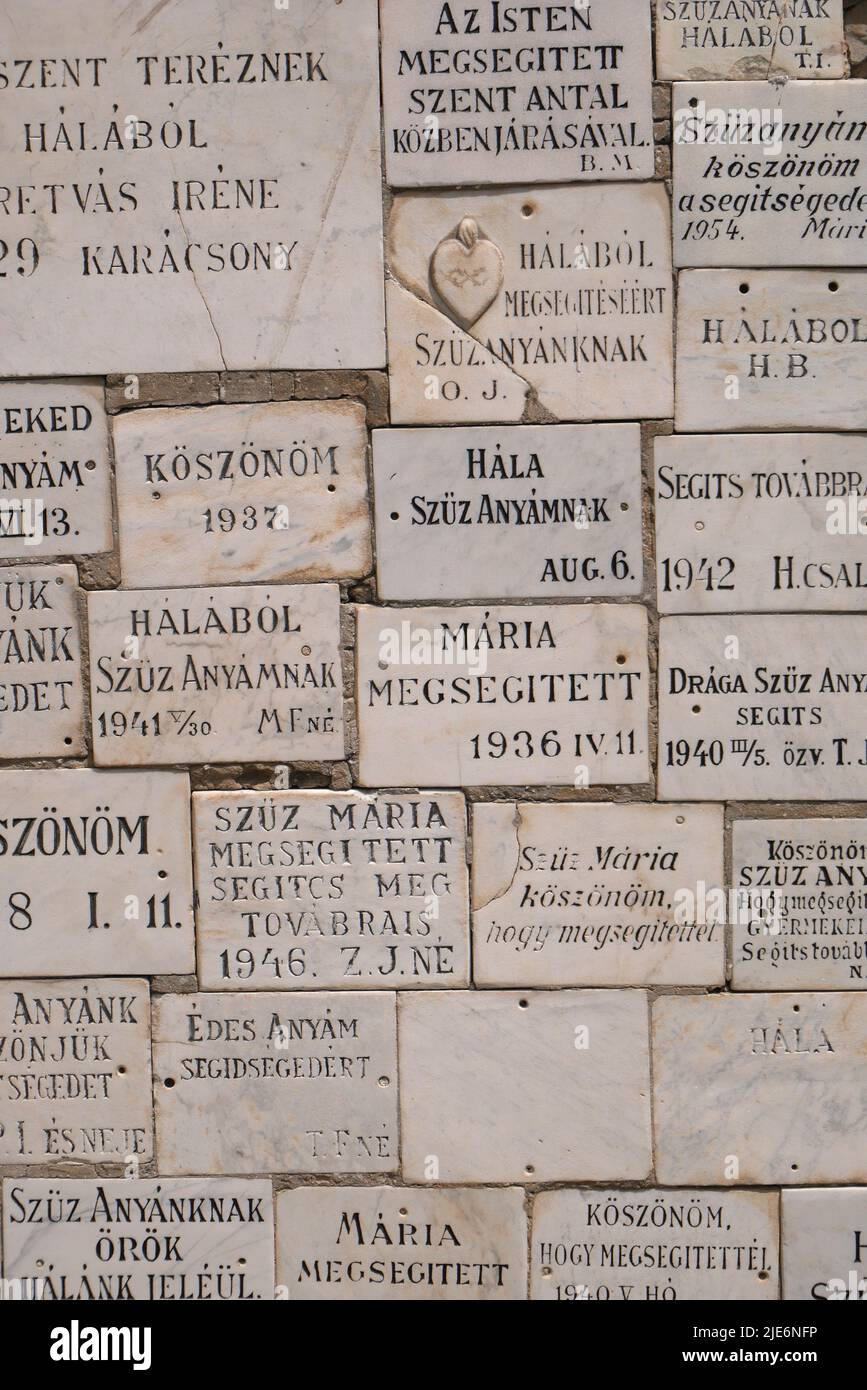 Placas conmemorativas en una pared junto a la puerta de entrada, Iglesia Católica de San Nicolás, Szent Miklos templom, Kecskemet, Hungría Foto de stock