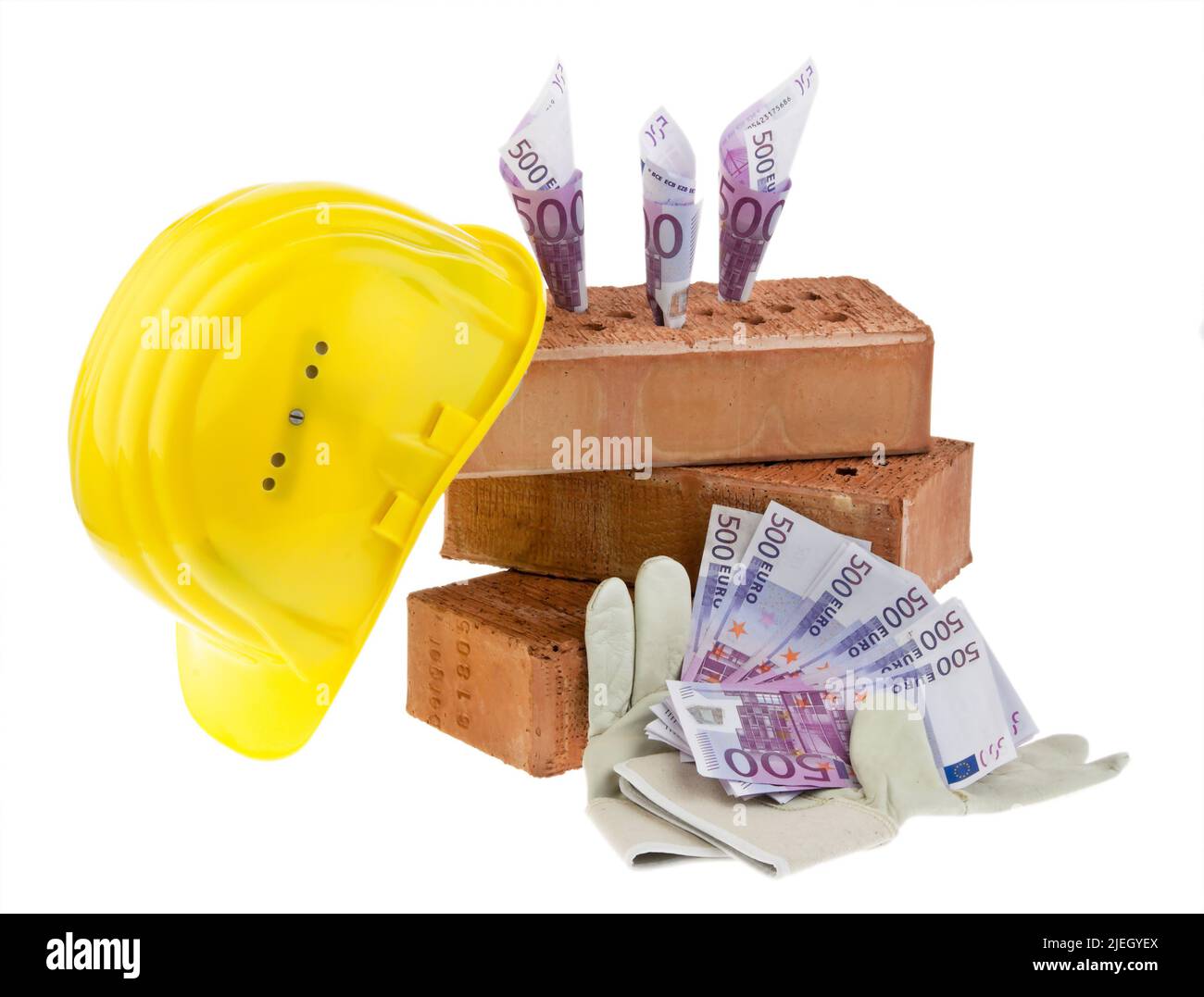 Symbolfoto Hausbau, Finanzierung, Bausparen. Ziegelsteine, Euro-Banknoten, gelber Schutzhelm, Handschuhe, Foto de stock